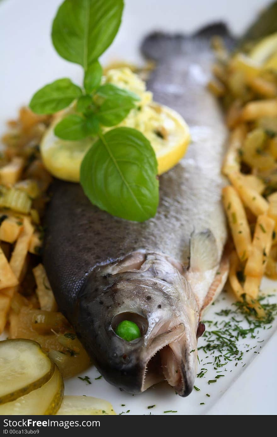 Oven trout with chips fries served with the lemon