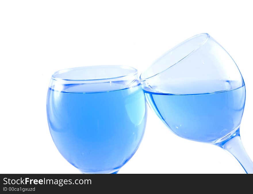 Glasses with a blue liquid on a white background