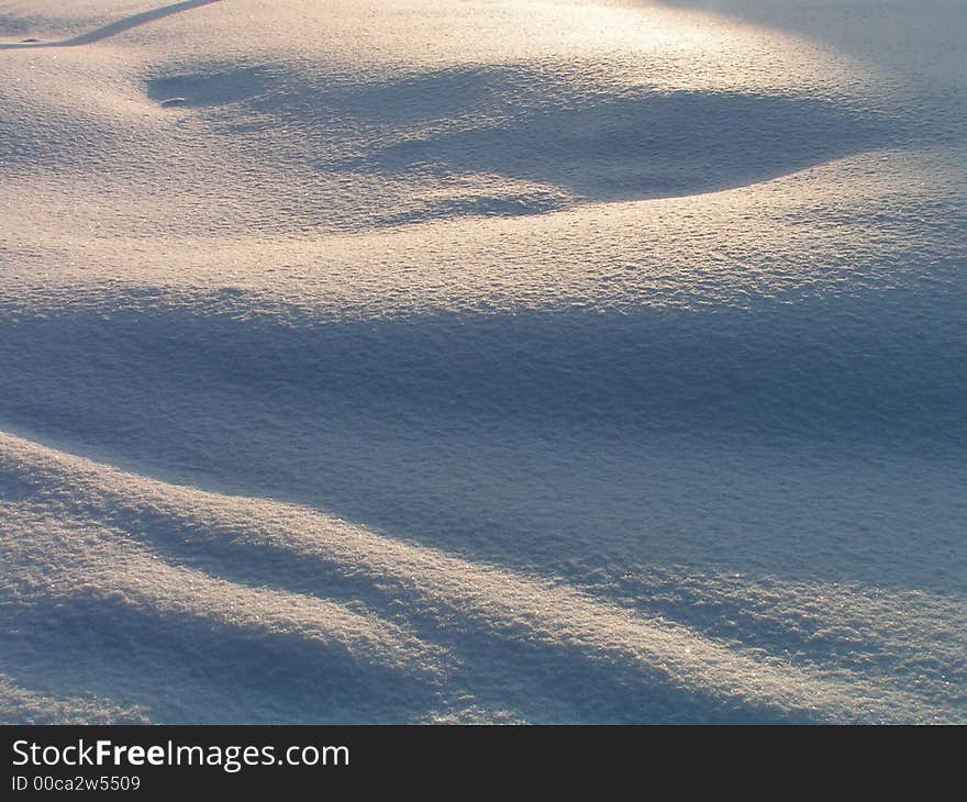 A snow cover covered by a sunlight. A snow cover covered by a sunlight.