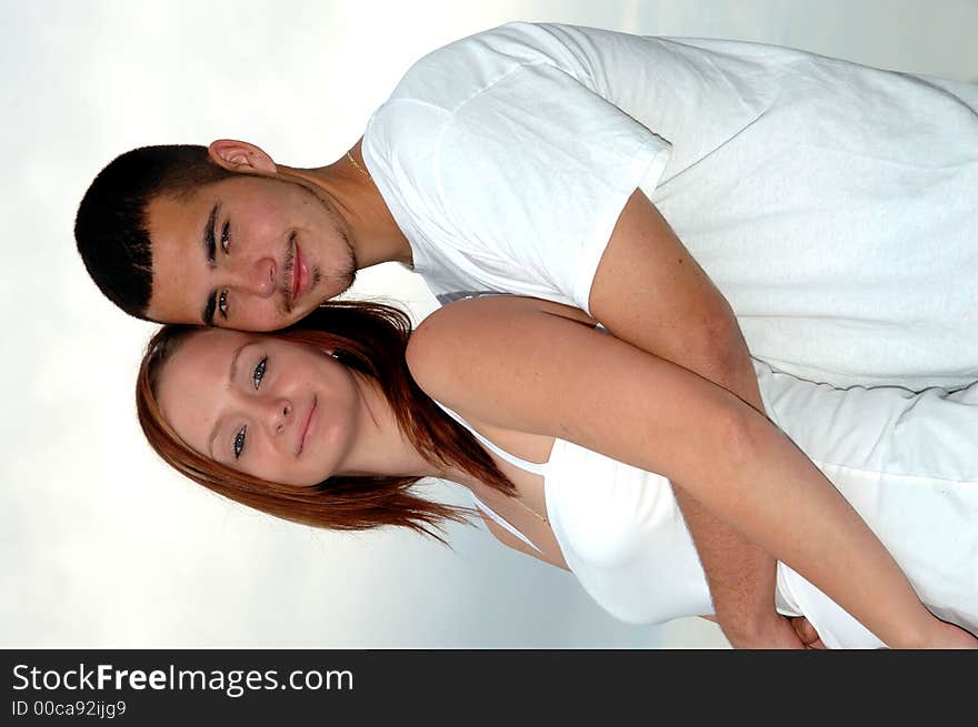 A happy young couple in an embrace outdoors. A happy young couple in an embrace outdoors