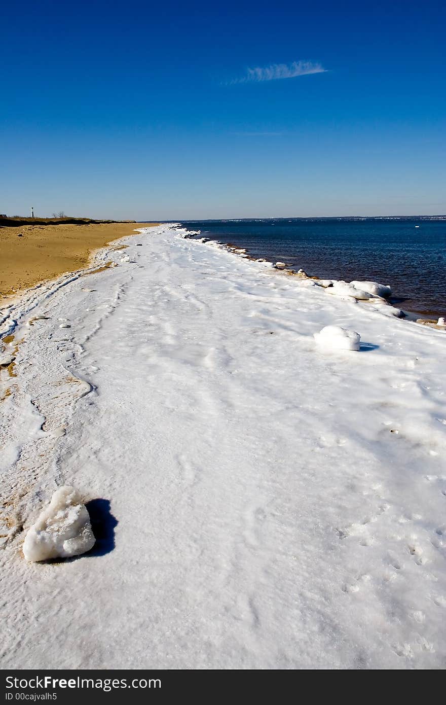 Frozen section of Atlantic beach with water and sand on either side. Frozen section of Atlantic beach with water and sand on either side.