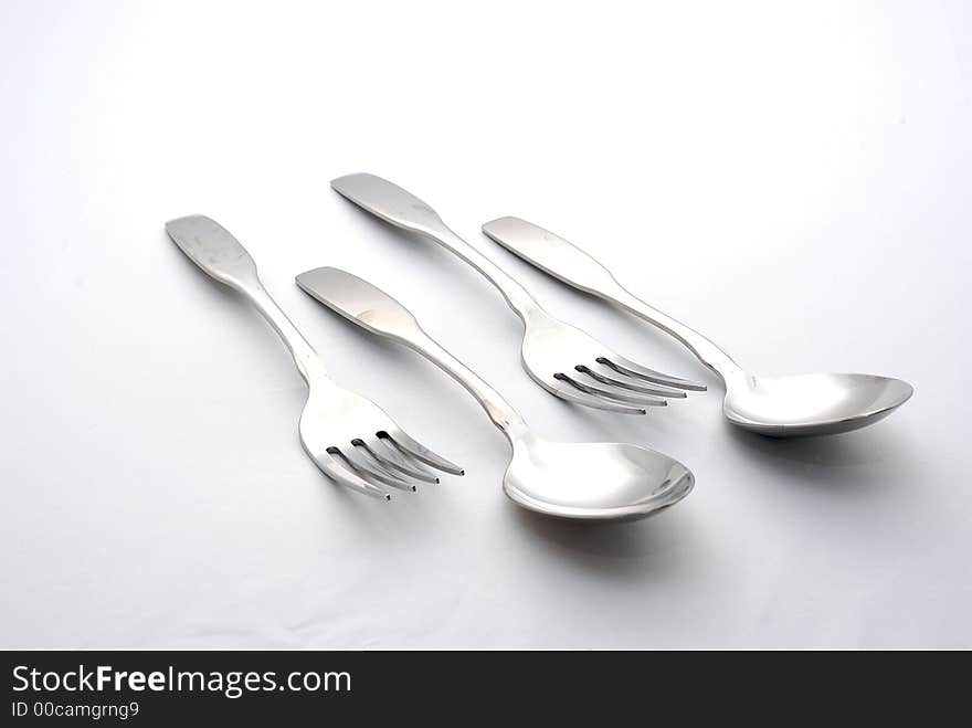 2 Pairs of fork and spoon on a white background. 2 Pairs of fork and spoon on a white background