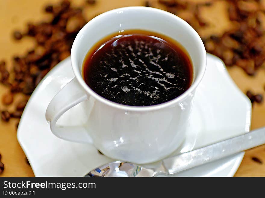 A pot of coffee on a wooden table. A pot of coffee on a wooden table