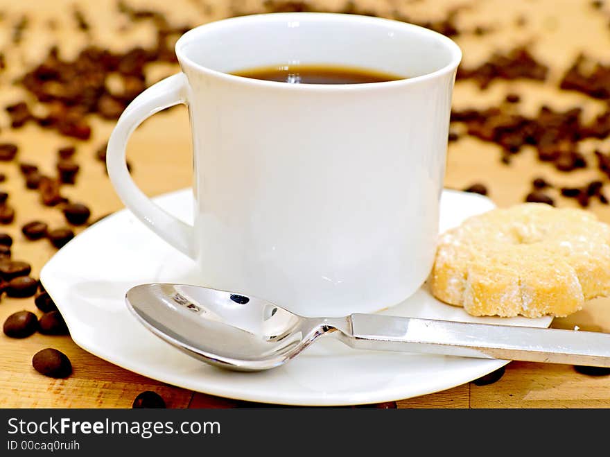 A pot of coffee on a wooden table. A pot of coffee on a wooden table