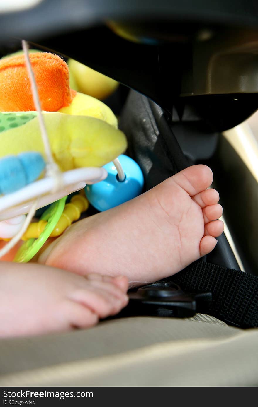 A little baby's feet inside a stroller. A little baby's feet inside a stroller