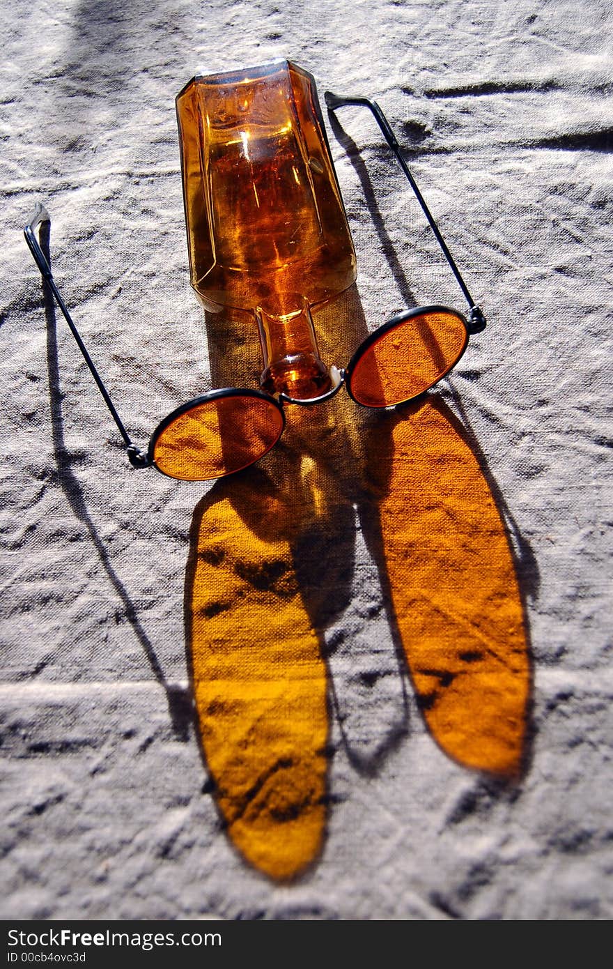 Orange bottle and glasses on the table