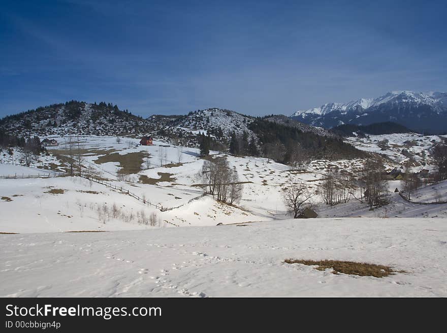 Winter landscape with red house