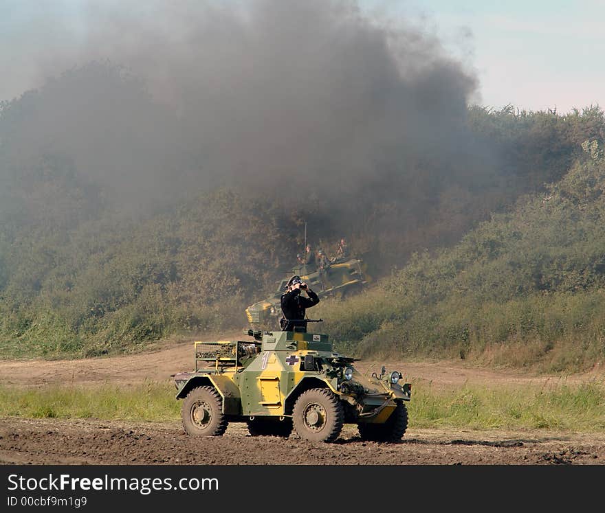 Military jeep, a soldier with field glasses.