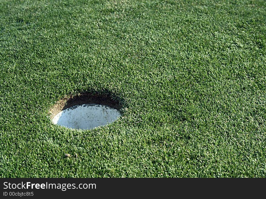 Golf cup on grass golf green