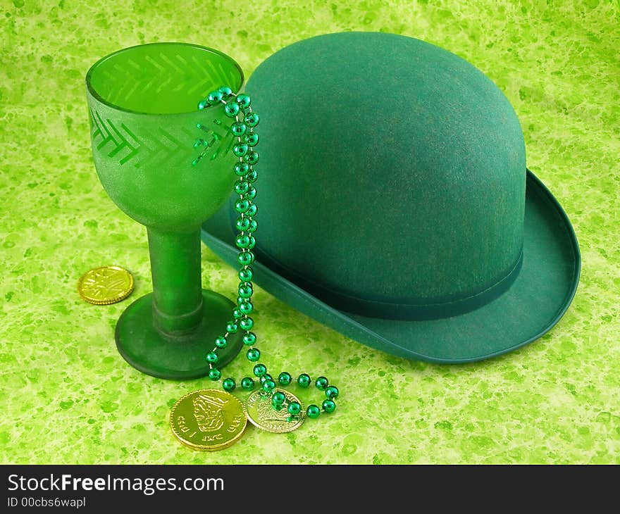 Sparkly green chalice with bowler hat and gold coins. Sparkly green chalice with bowler hat and gold coins