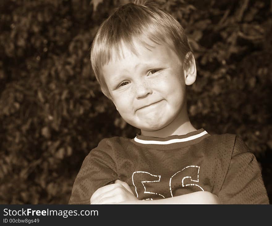 Young blonde boy done in sepia with expression