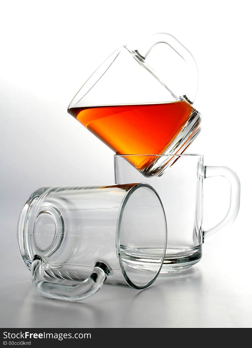 Three glass mugs and black tea, Isolated