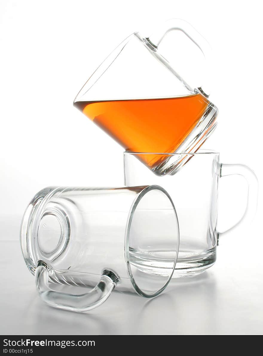 Three glass mugs and black tea, Isolated