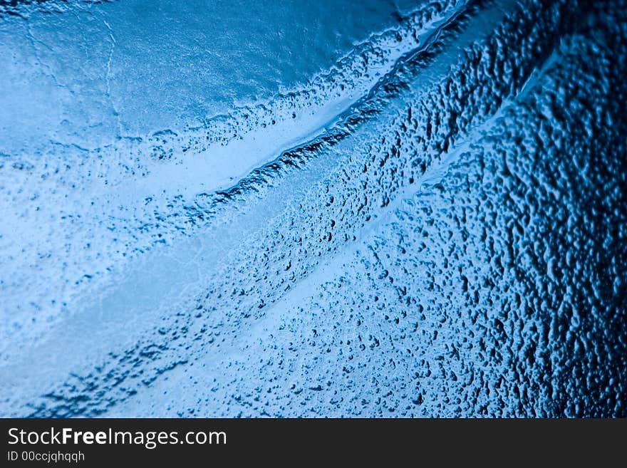 Detail of a bubbled glass with blu natural gradient. Detail of a bubbled glass with blu natural gradient