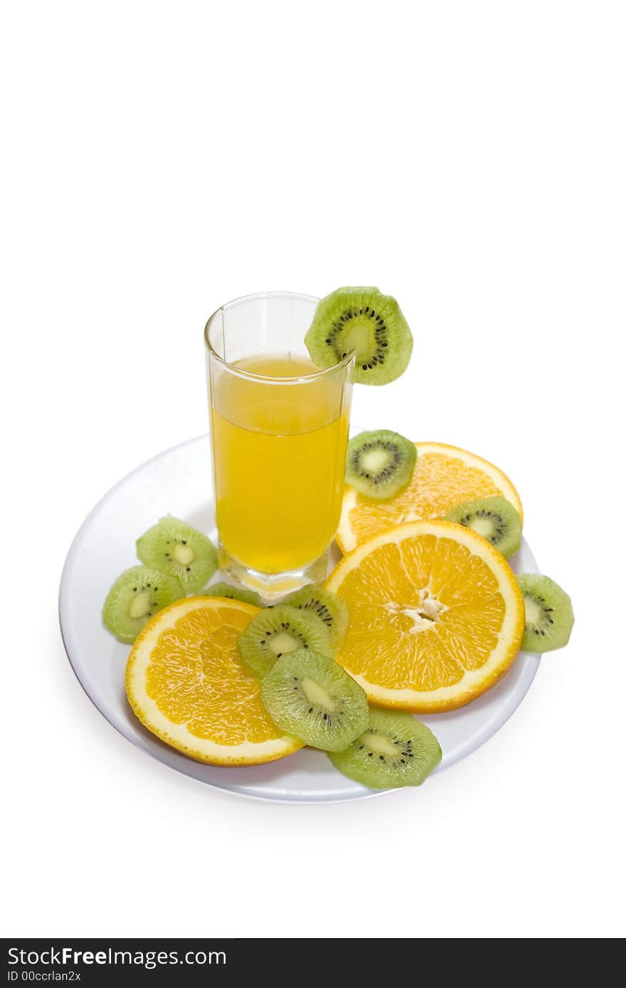 Glass of orange juice and fruits slices on a plate. Glass of orange juice and fruits slices on a plate