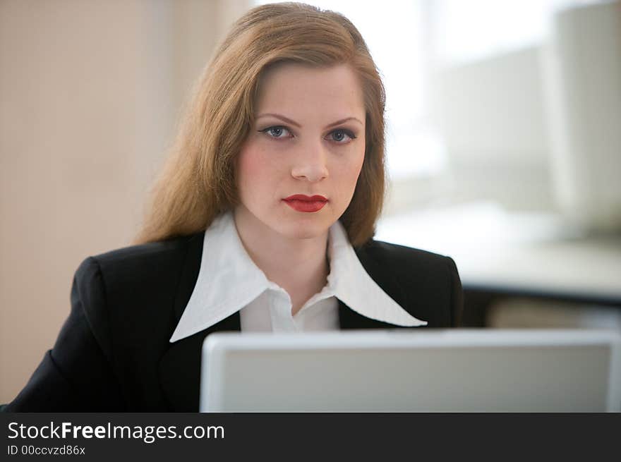 Businesswoman at her desk with a notebook. Businesswoman at her desk with a notebook