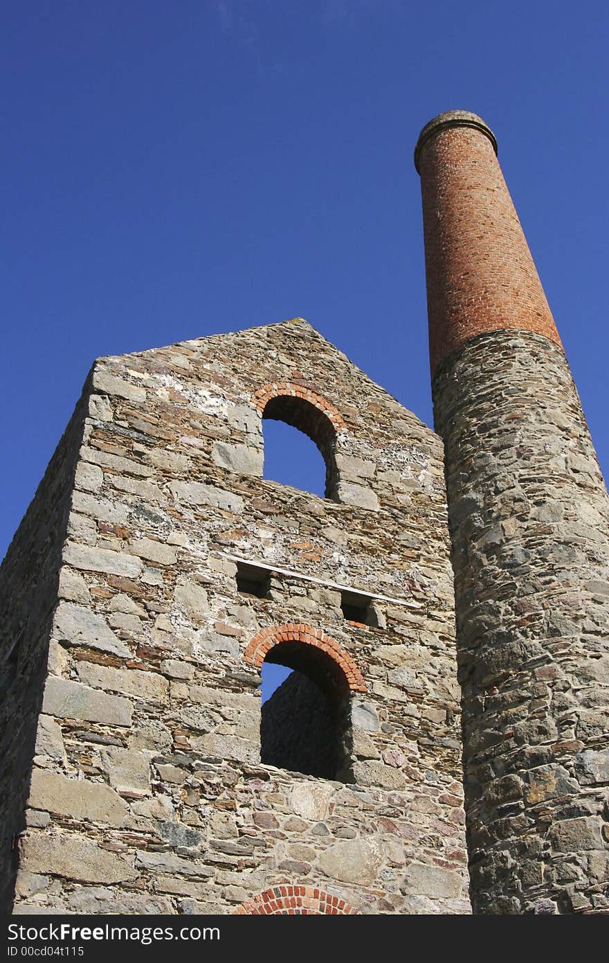 A Cornish pumping engine house framed against a clear blue sky. A Cornish pumping engine house framed against a clear blue sky.