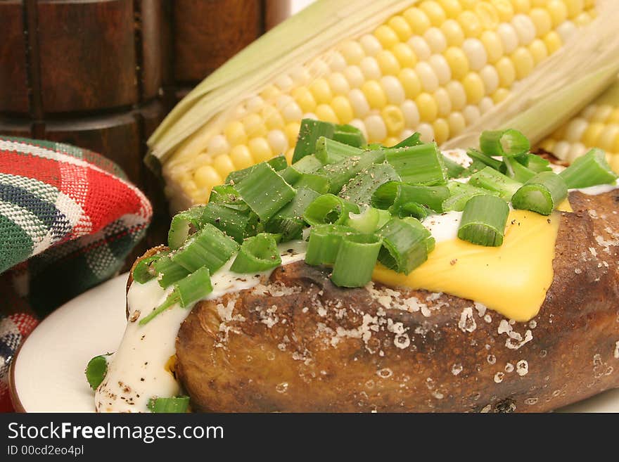 Baked potato & corn on the cob upclose