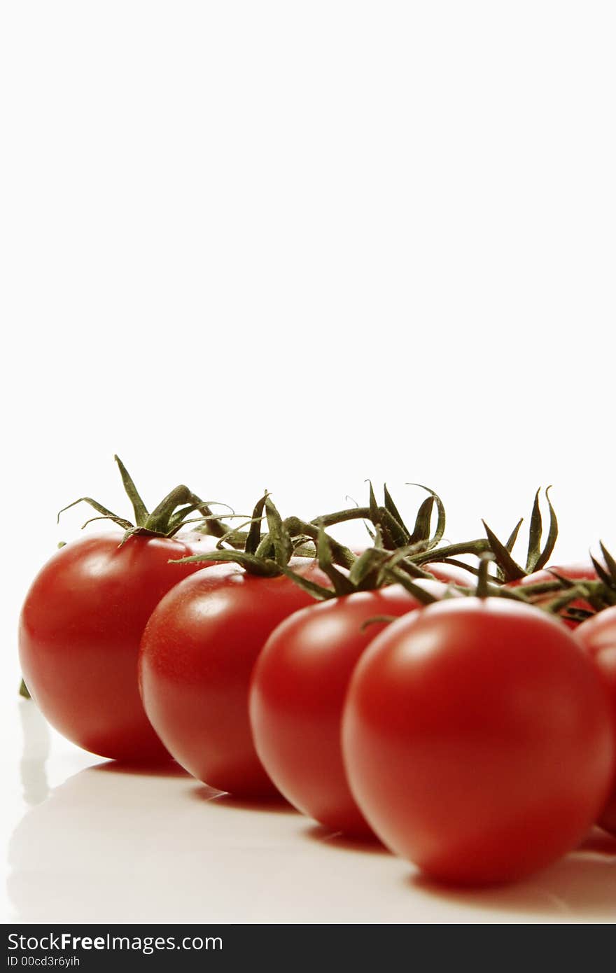 Red tomatoes over white background