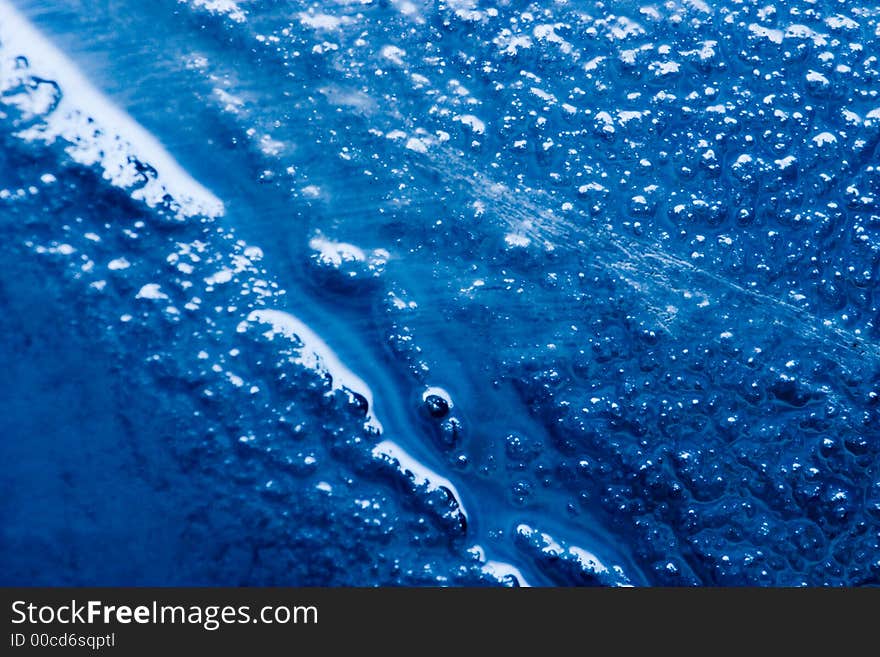 Detail of a bubbled glass with blu natural gradient. Detail of a bubbled glass with blu natural gradient