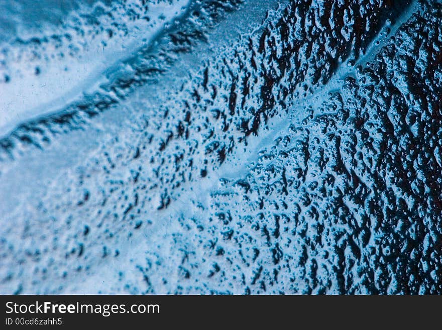 Detail of a bubbled glass with blu natural gradient. Detail of a bubbled glass with blu natural gradient