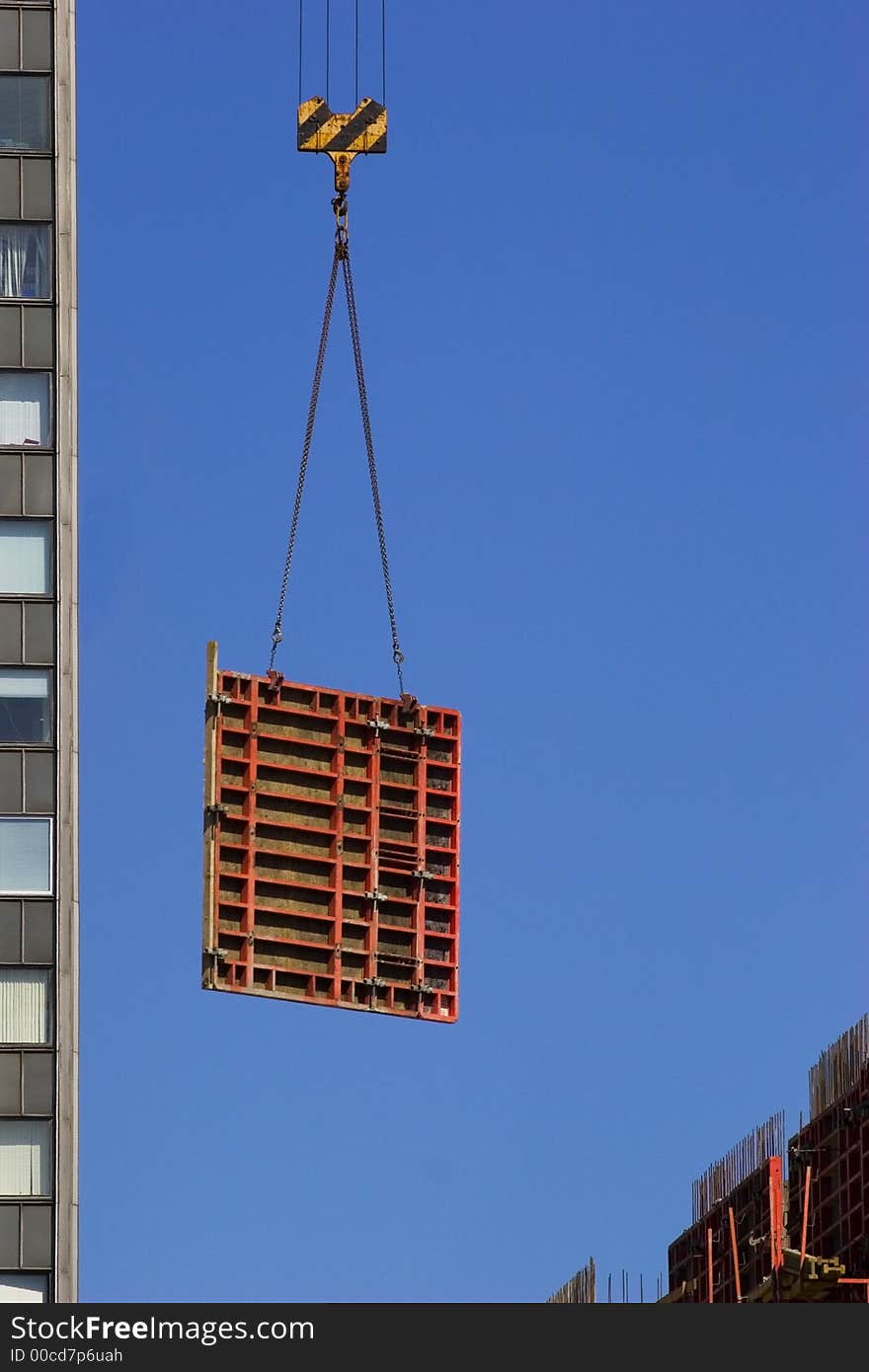 Hoisting concrete block. Building new skyscraper