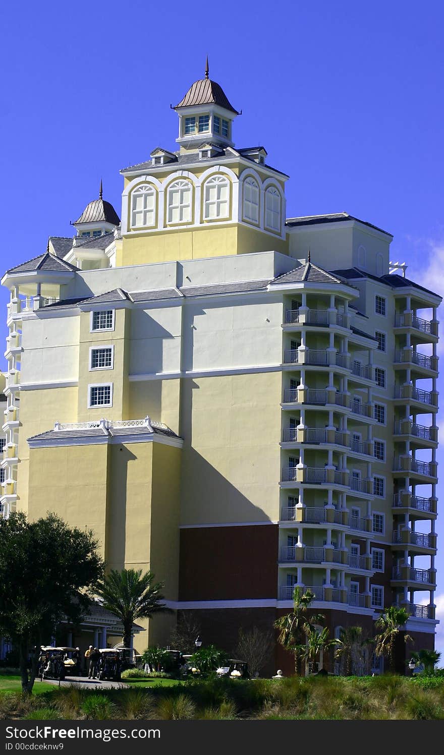 New pale yellow high rise resort hotel against blue sky. New pale yellow high rise resort hotel against blue sky