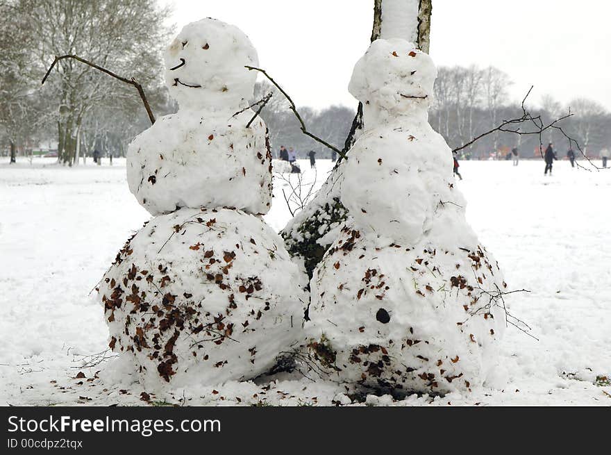 Snowmen in wintery park setting