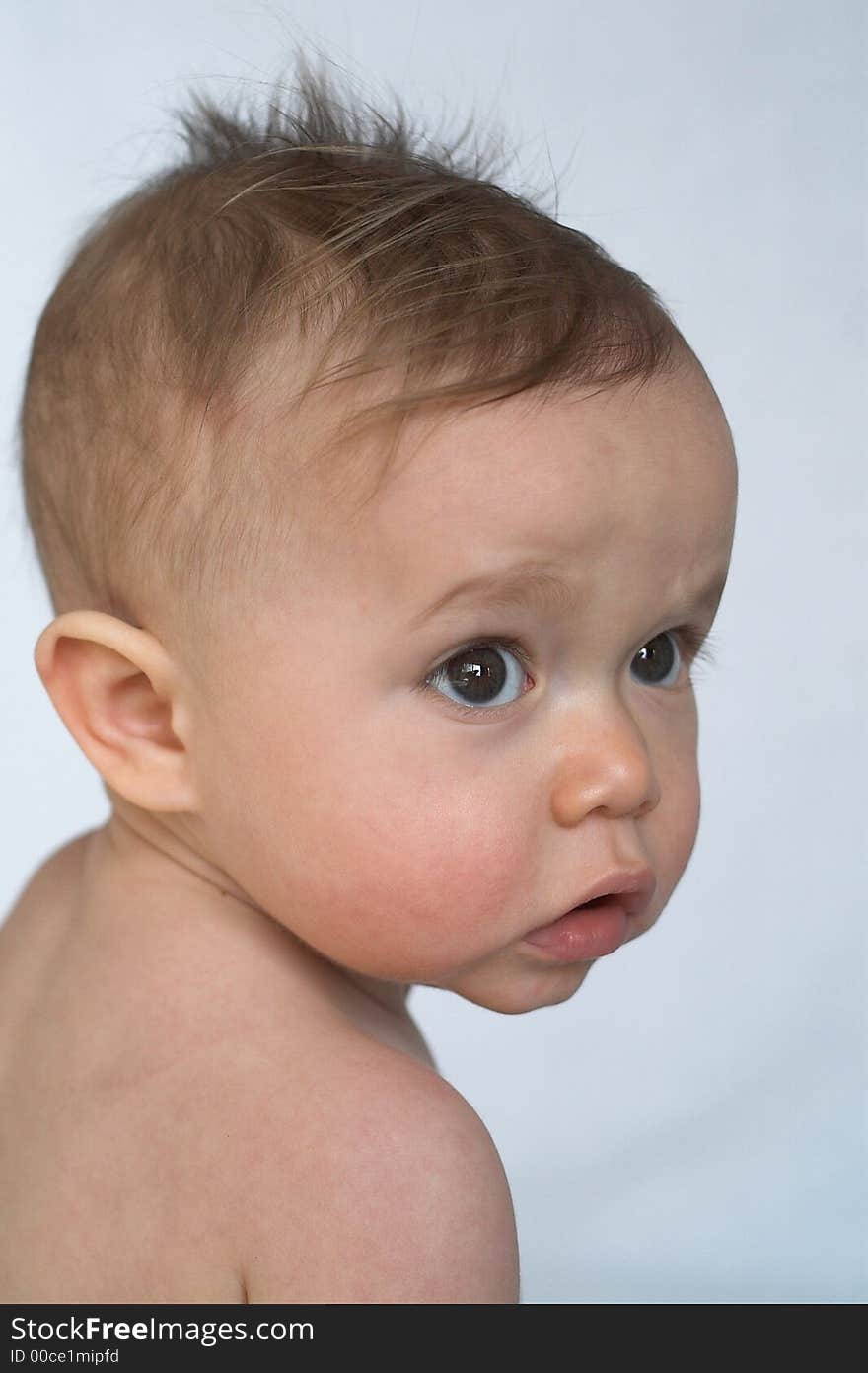 Portrait of beautiful 10 month old baby sitting in front of white background. Portrait of beautiful 10 month old baby sitting in front of white background