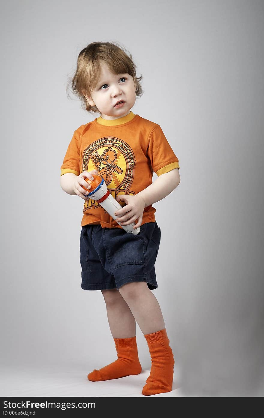 Little singer with microphone on white background