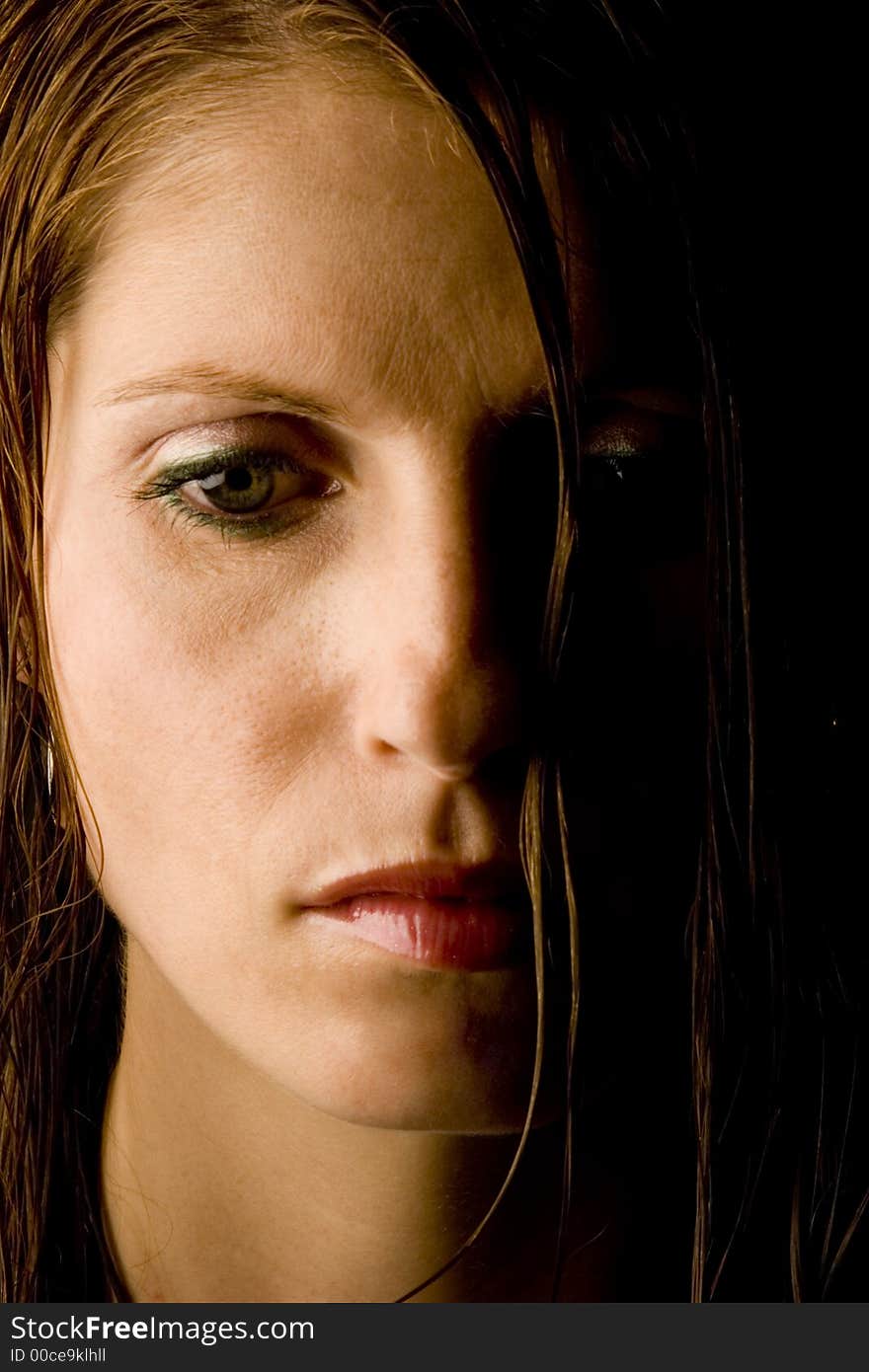 A young woman with wet hair against a plain background.