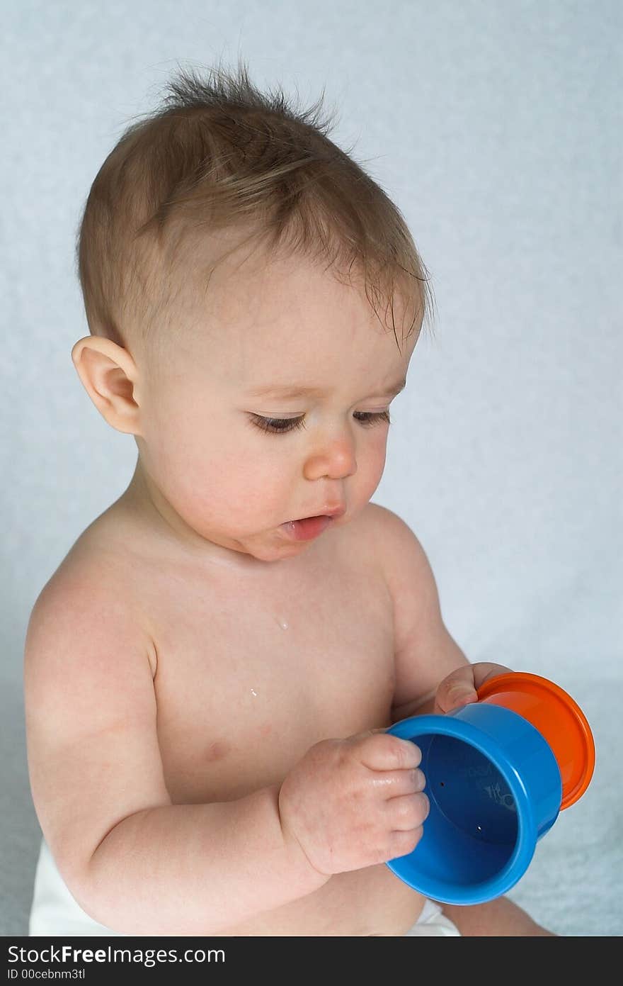 Image of adorable baby playing with stacking cups. Image of adorable baby playing with stacking cups