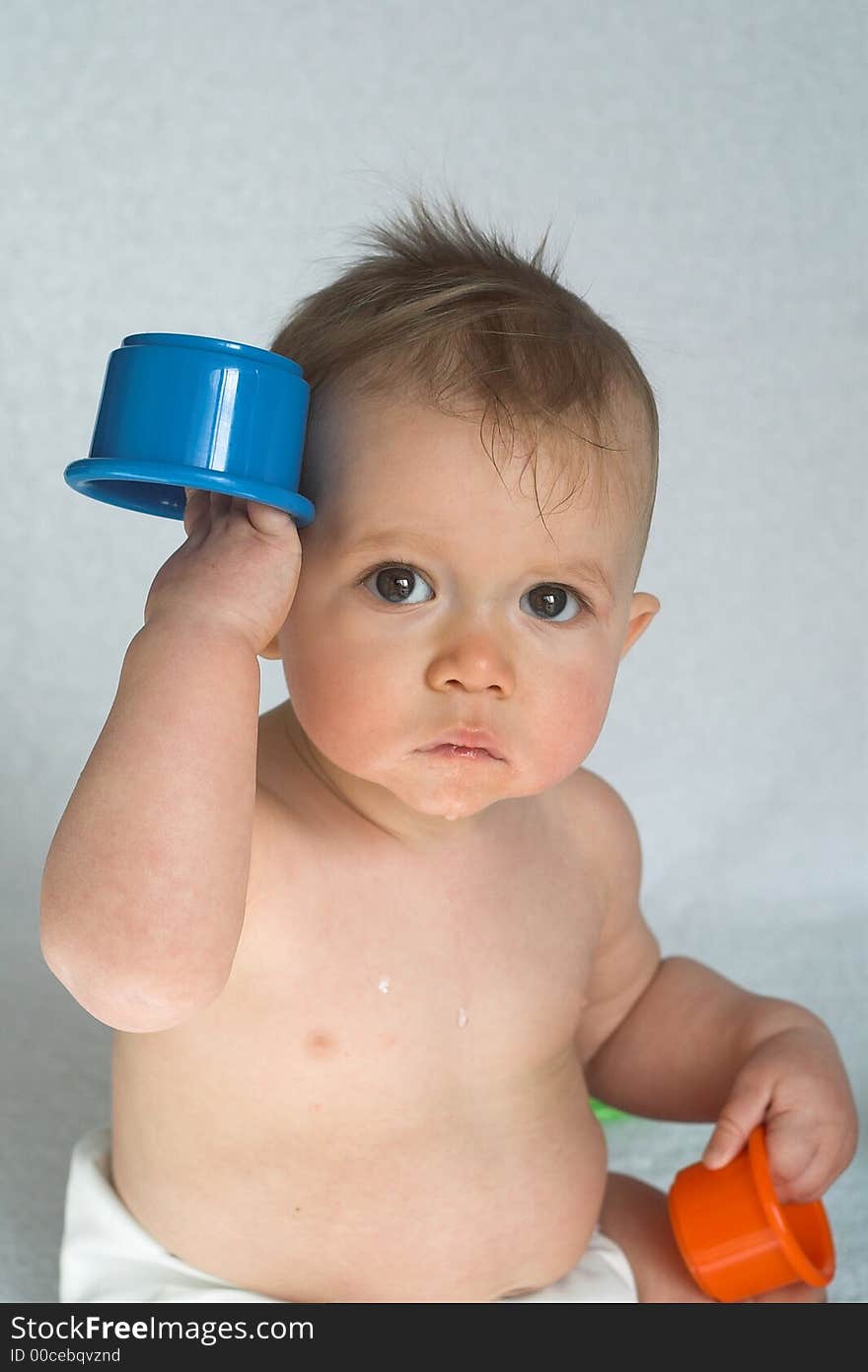 Image of adorable baby playing with stacking cups. Image of adorable baby playing with stacking cups