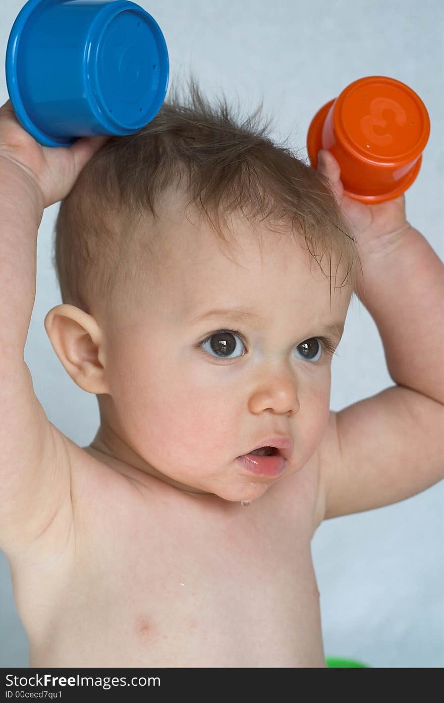 Image of adorable baby playing with stacking cups. Image of adorable baby playing with stacking cups