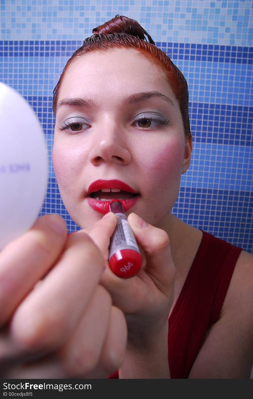 Girl with dyeing coloring her lips. Girl with dyeing coloring her lips