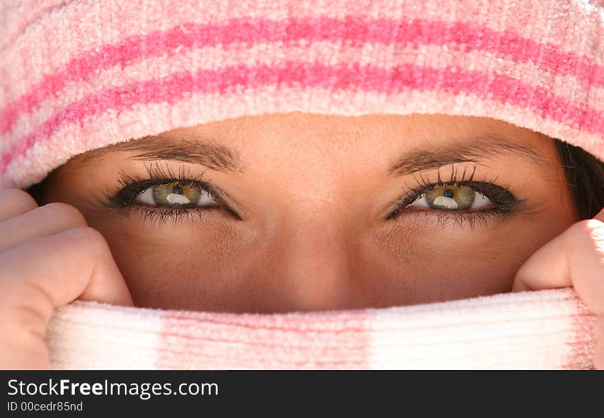 Young woman with beautiful eyes covering nose and mouth