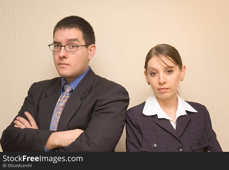 Two business persons looking at the camera with concern. Two business persons looking at the camera with concern