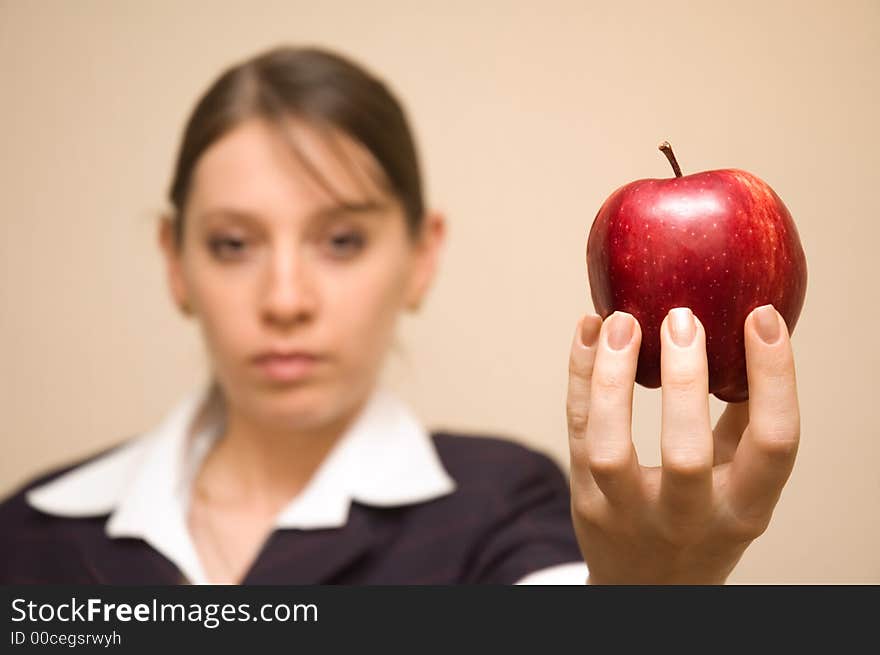 Beautiful woman offering a very tempting apple. Beautiful woman offering a very tempting apple