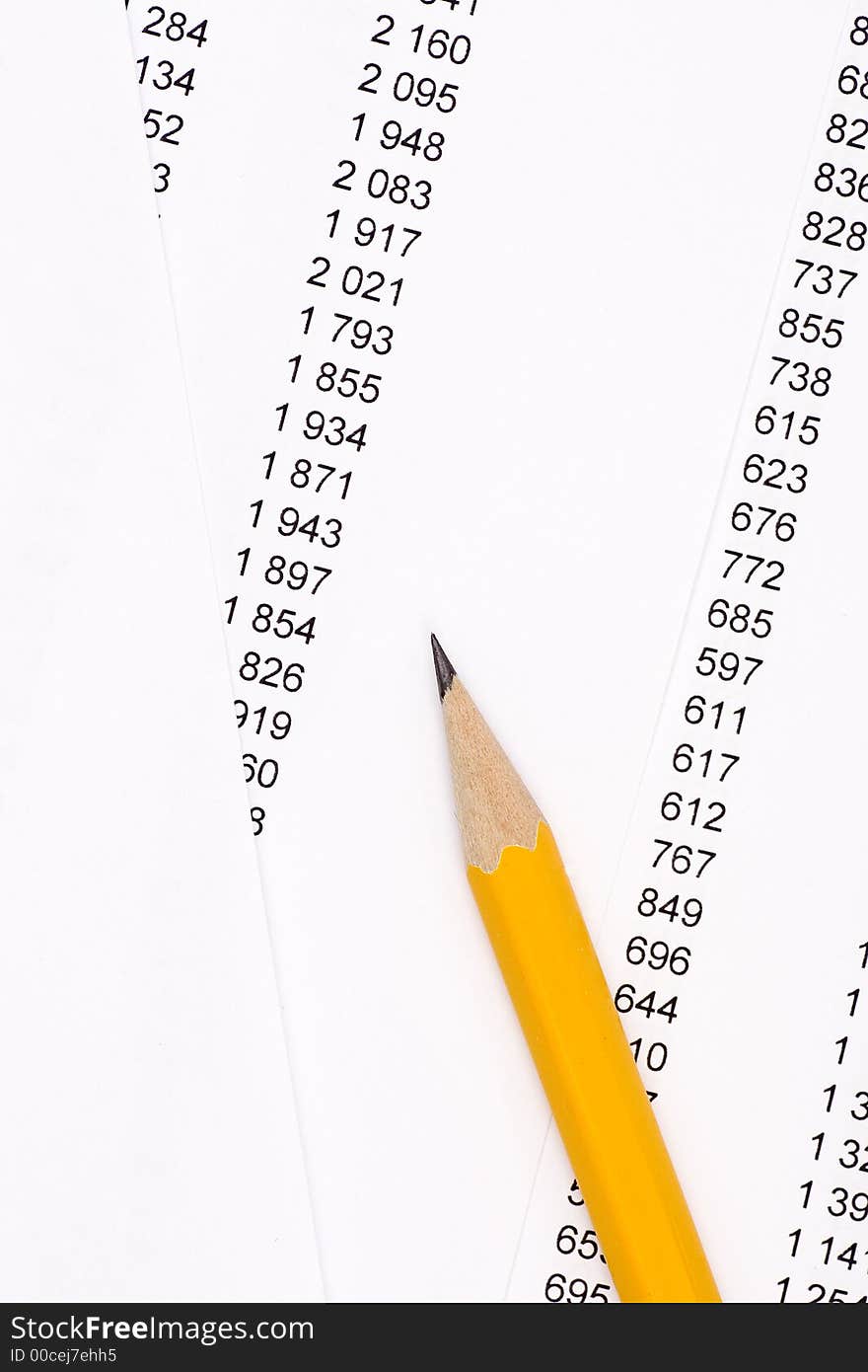 Yellow pencil on documents and numbers