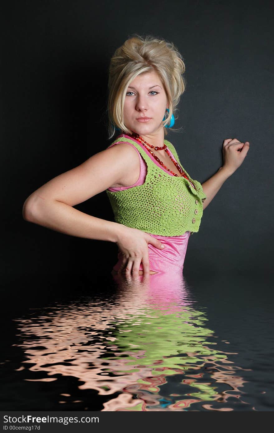 A beautiful girl posing in fashion poses and creative outfits with water reflections