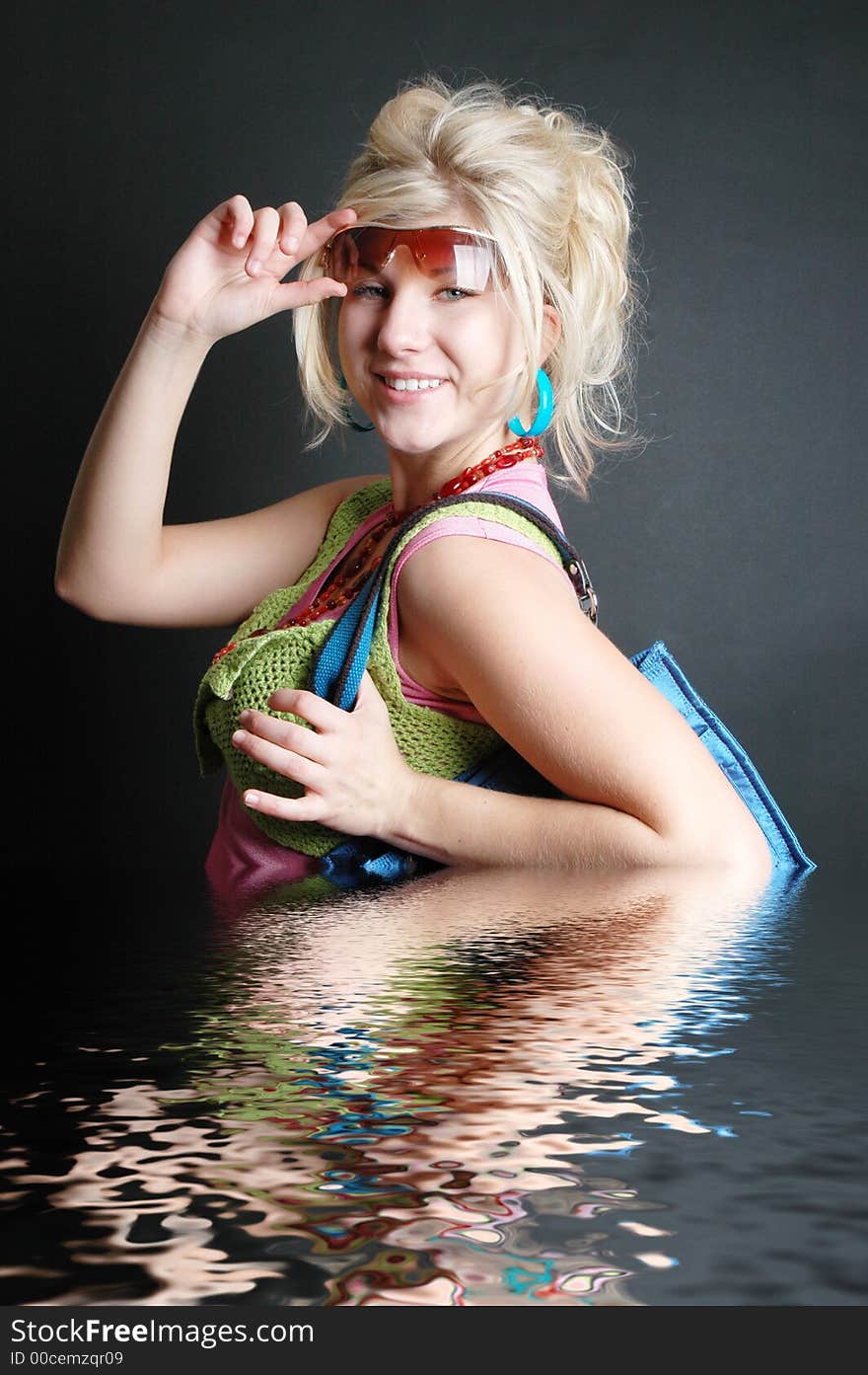 A beautiful girl posing in fashion poses and creative outfits with water reflections