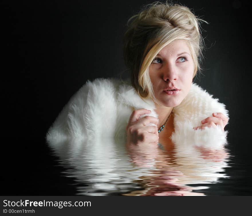 A beautiful girl posing in fashion poses and creative outfits with water reflections