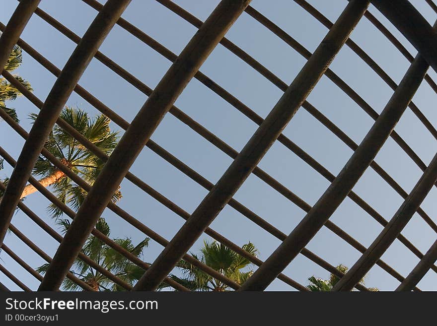 Trellised roof against a background of the blue sky. Trellised roof against a background of the blue sky