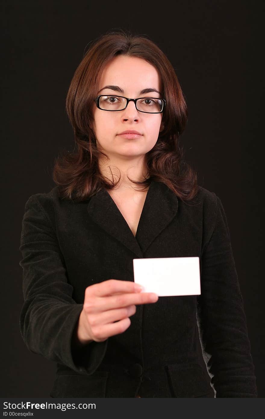 Business woman showing a blank business card to you, black background