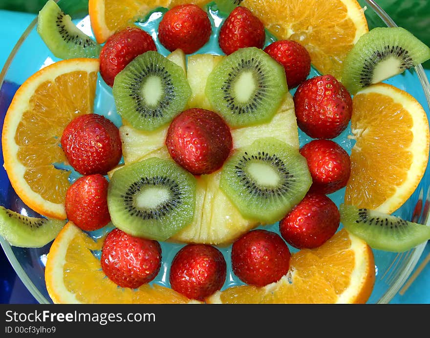 Orange, strawberries, kiwi and other fruits in a salad. Orange, strawberries, kiwi and other fruits in a salad