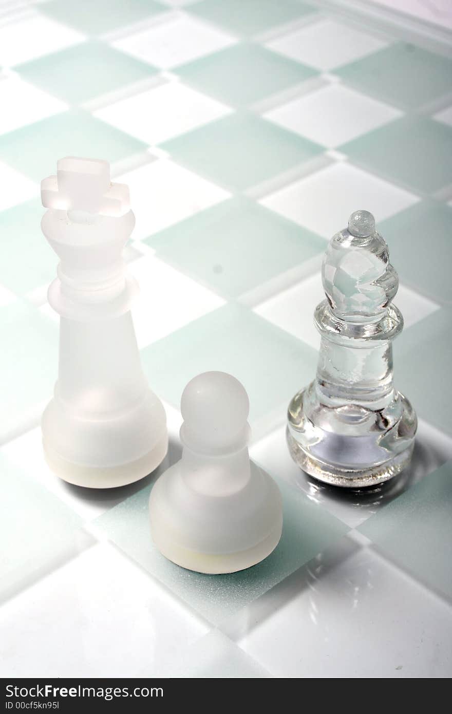 High key Glass Chess Pieces on a sandblasted glass chess board