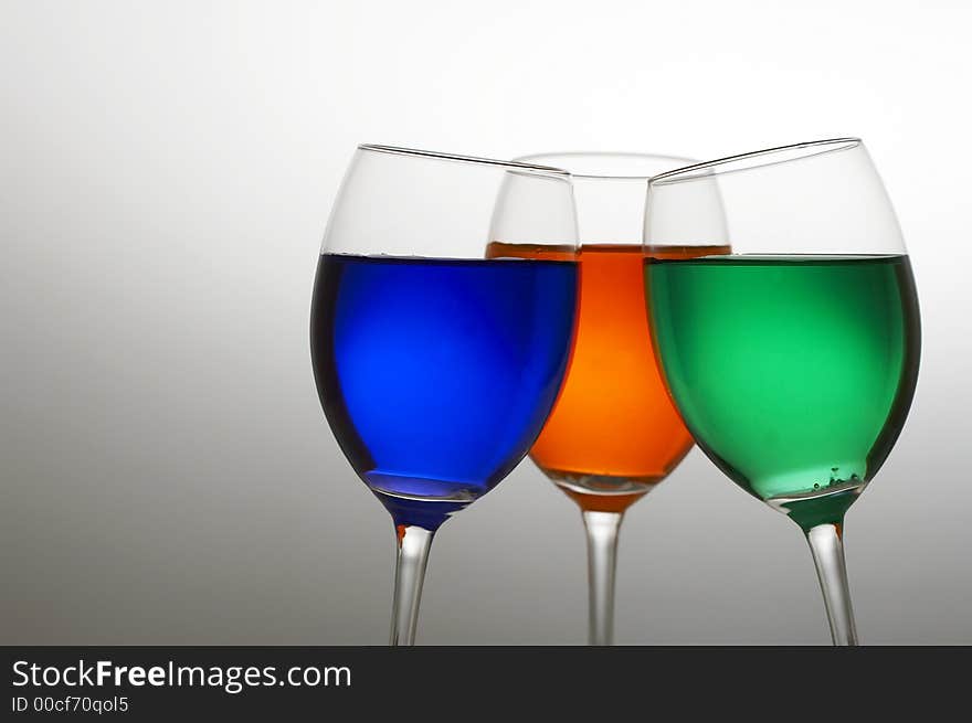 Wine glasses with three colors of drink