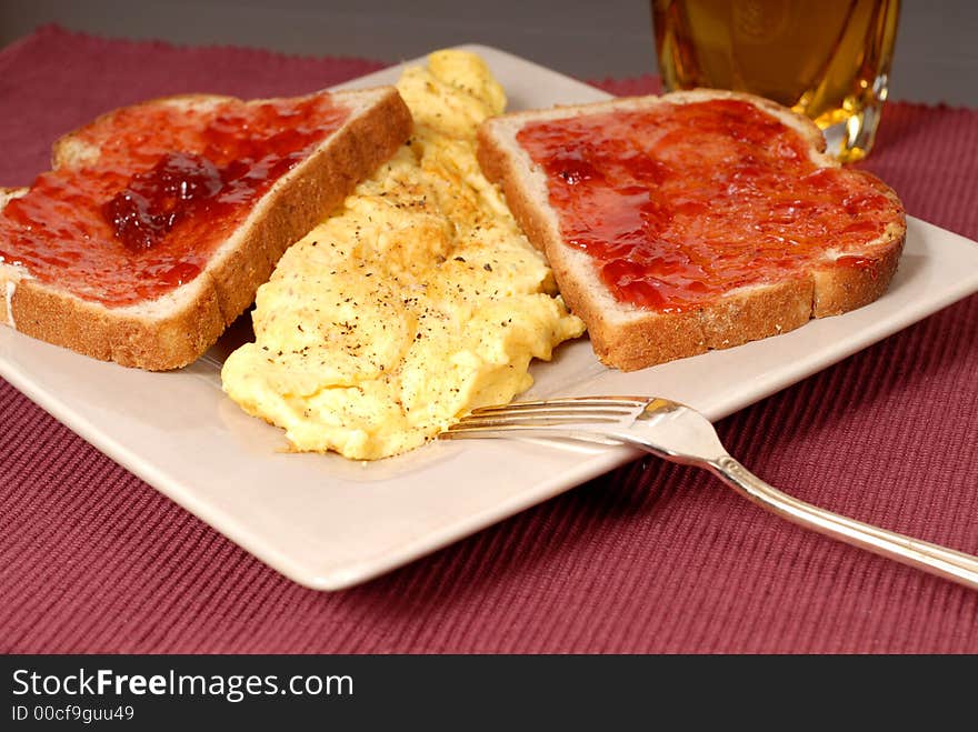 Omelette with toast, strawberry jam and apple juice