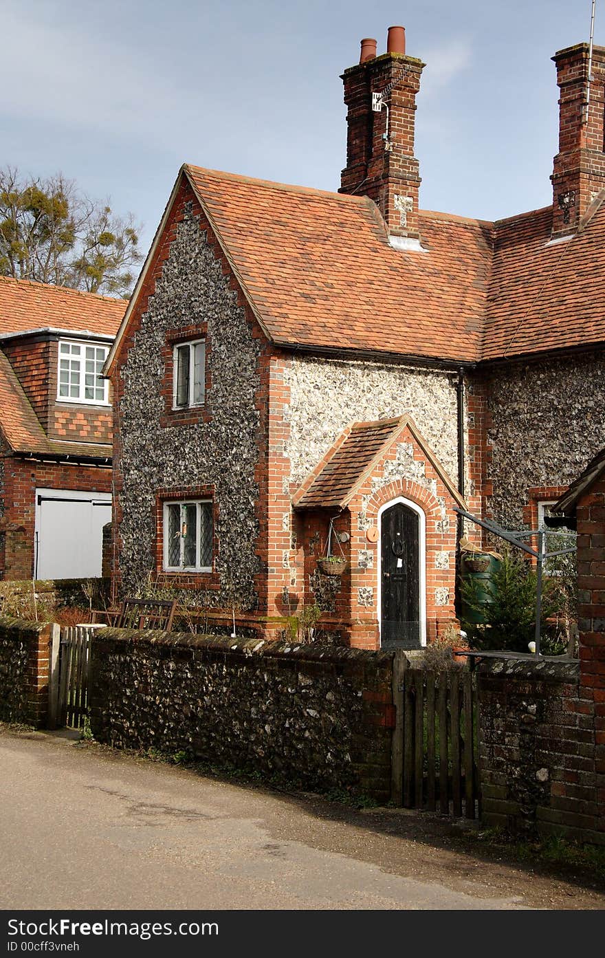 Quaint Brick and Flint Cottages on a Village Road in England