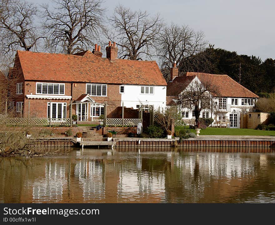 House with Boat Moorings on the banks of a River in England. House with Boat Moorings on the banks of a River in England